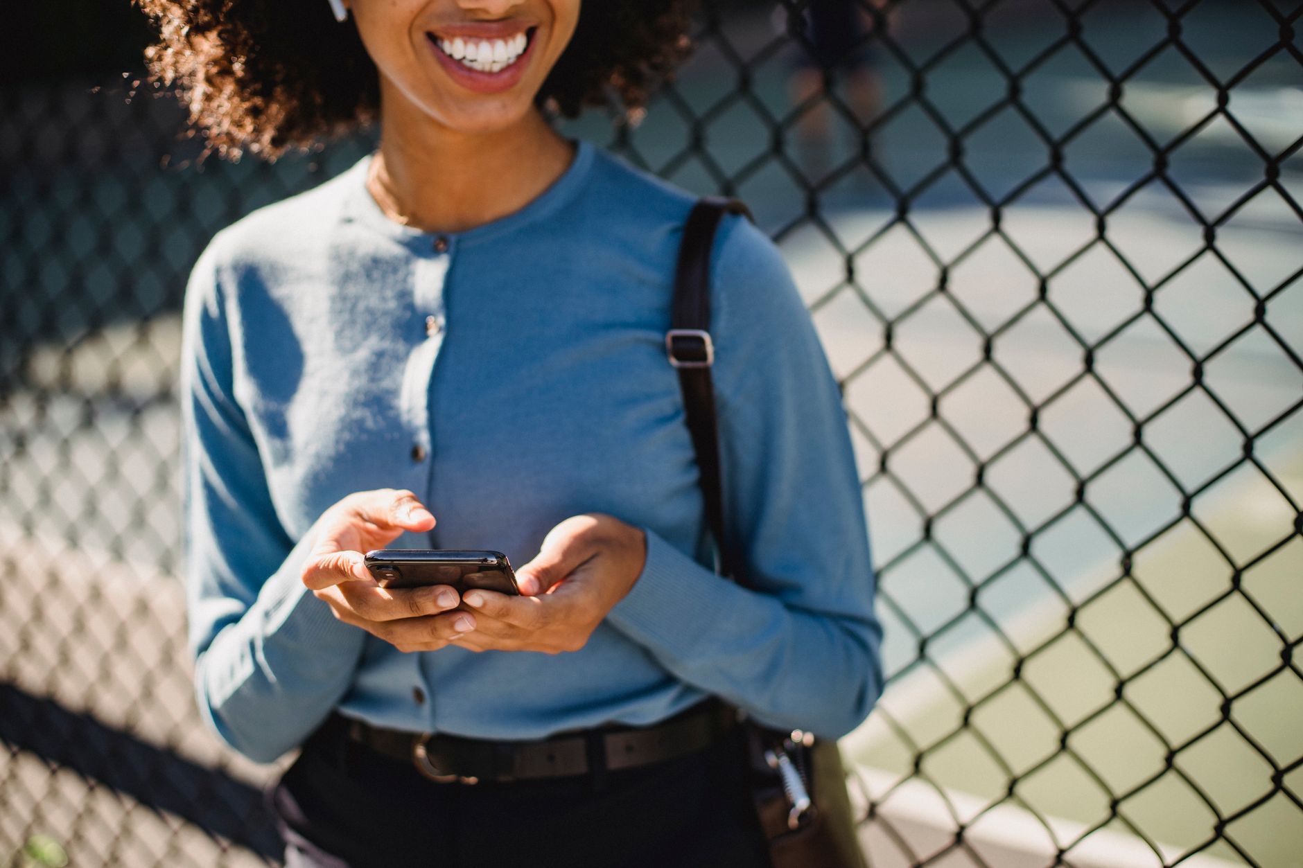 Woman checking her phone after a same-day cash loan e-Transfer