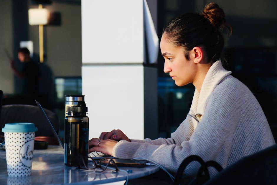 Young woman using laptop at cafe in Quebec - rapid cash loans Canada online