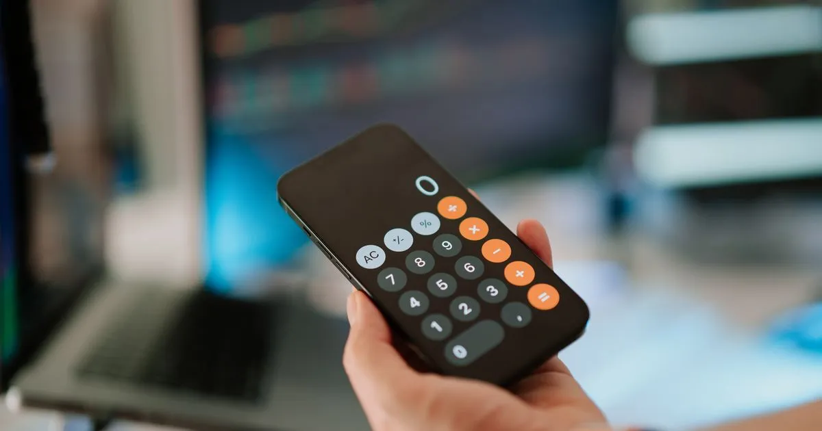 Adding up cash advance apps express fees and tips on a phone calculator