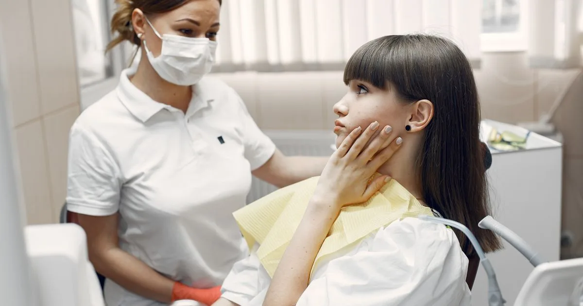 Dentist examining a patient with tooth pain at an emergency dental clinic