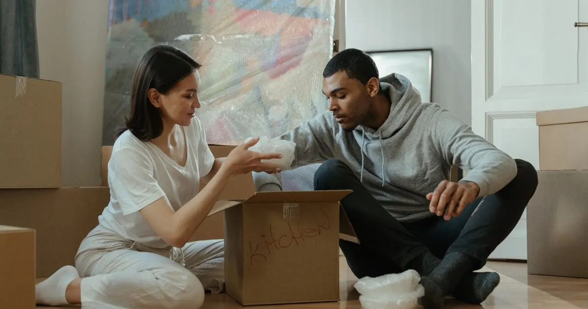 Renter unpacking in a new home after using a moving loan