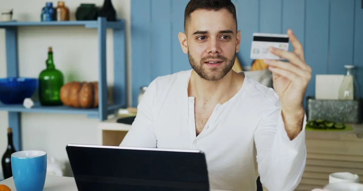 Applying for a short term loan online with a bank card and laptop