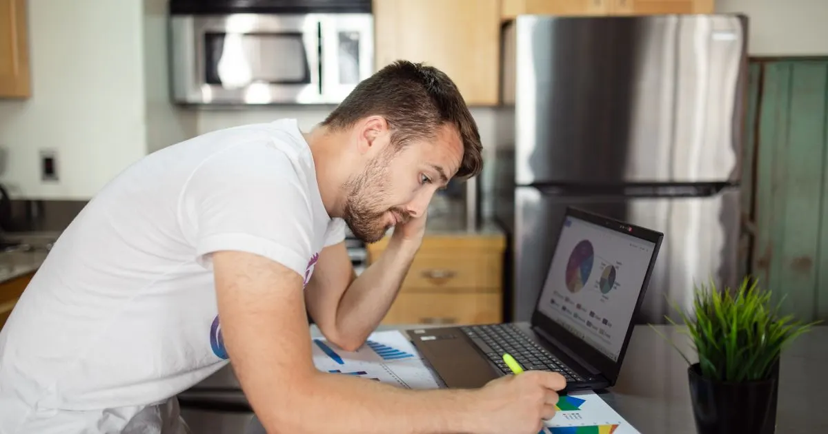 Man reviewing his budget before applying for a short term loan