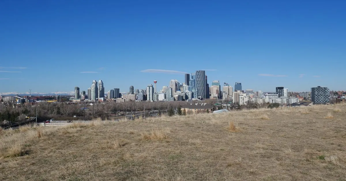 Calgary skyline and Calgary Tower from a park - e-transfer loans Calgary same-day funding