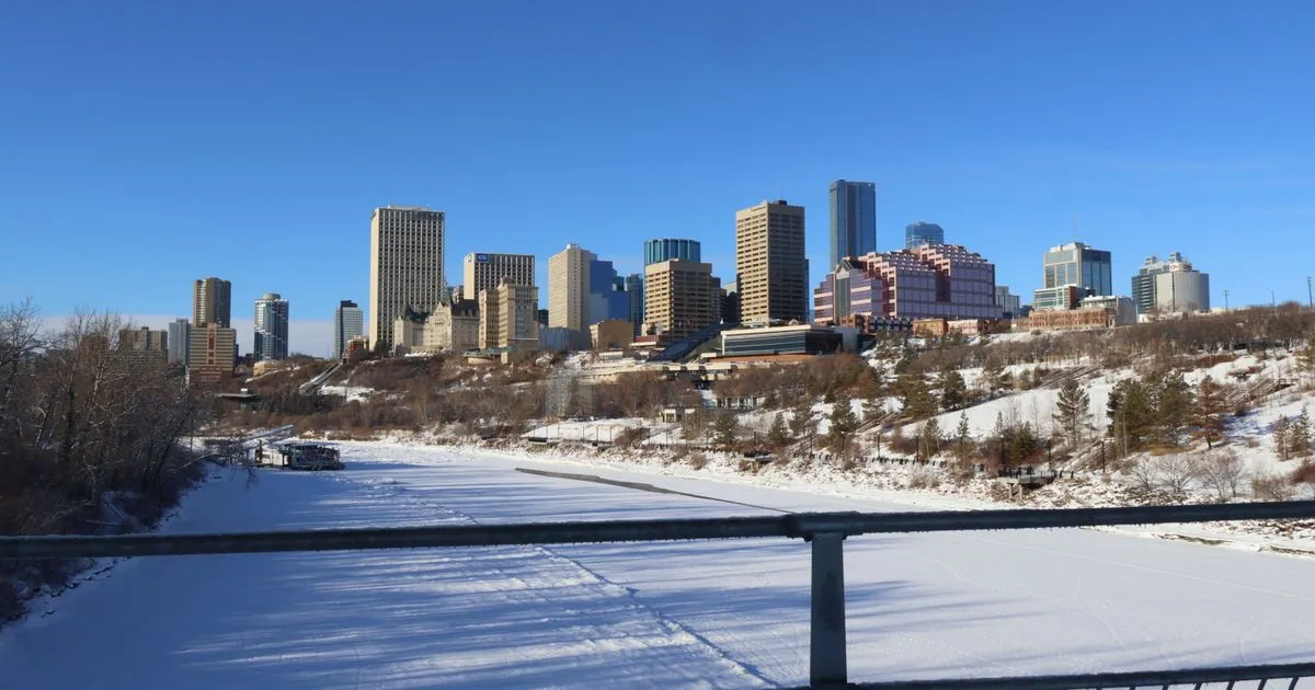 Emergency loans Alberta borrowers apply for online, with the Edmonton skyline above the frozen North Saskatchewan River
