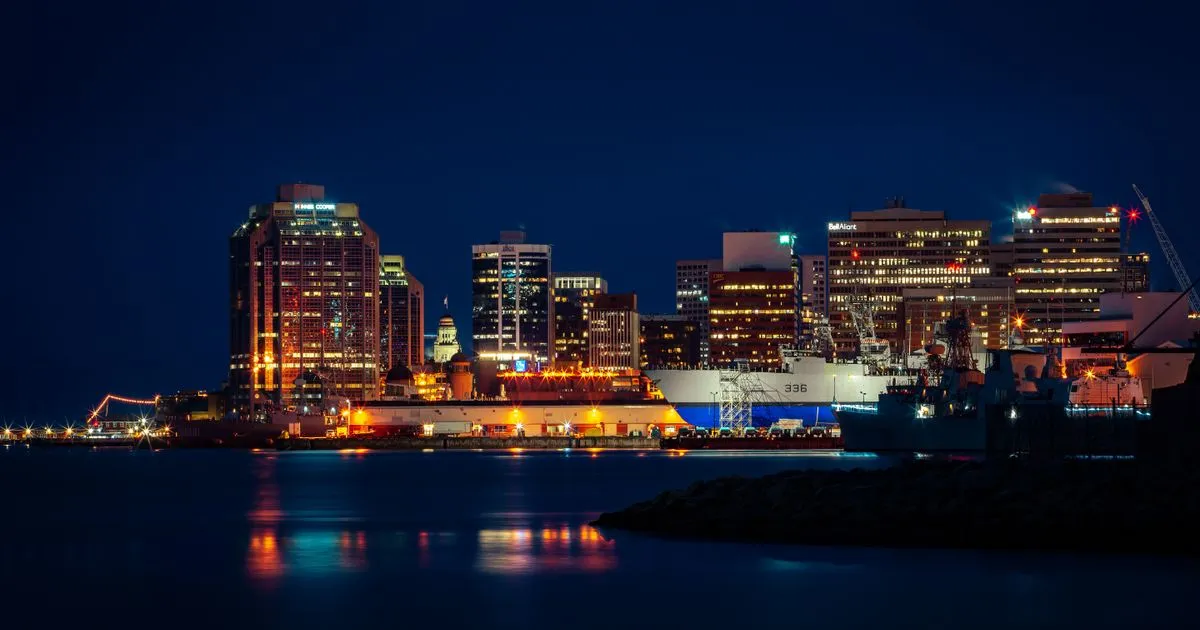 Rapid cash loans Nova Scotia residents get by e-Transfer, with the Halifax harbour skyline at night