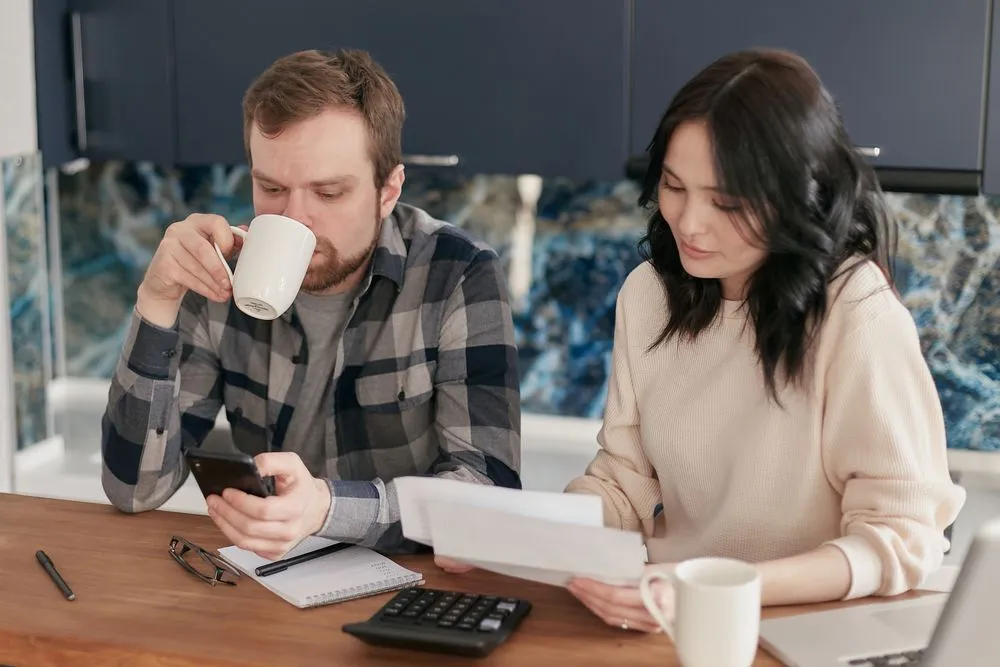 Working out what Bree costs against the monthly budget at the kitchen table