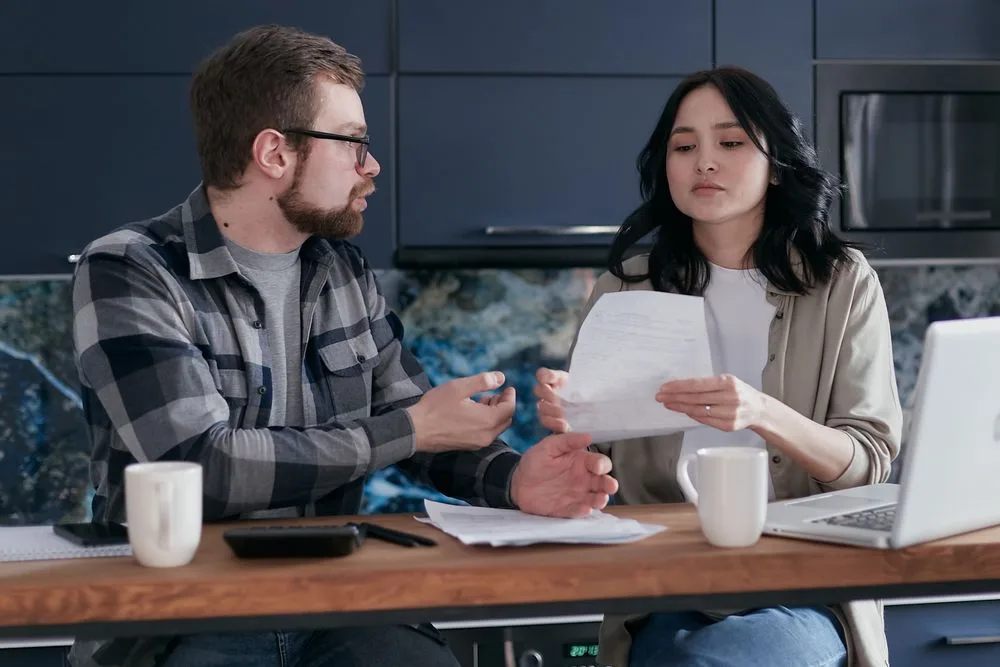 Couple reviewing an Equifax credit report at the kitchen table after using Nyble